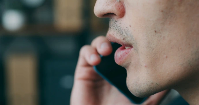 A close up of a person talking on a cell phone